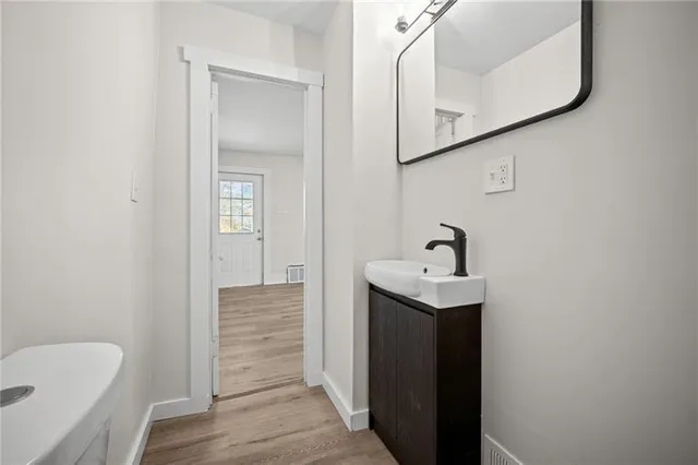 a bathroom with a sink a toilet and mirror