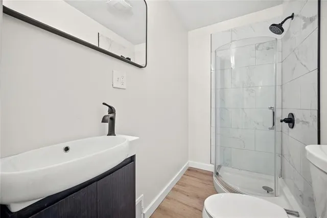 a bathroom with a sink toilet and shower