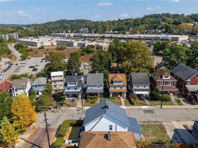 an aerial view of residential houses with outdoor space and river