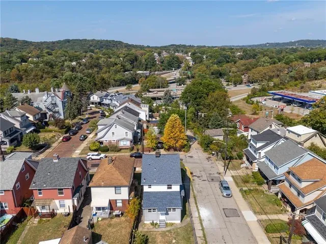 an aerial view of residential houses with outdoor space