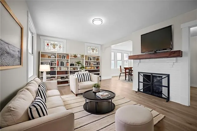 a living room with furniture and a fireplace