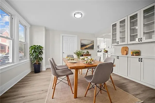 a view of a dining room with furniture and a potted plant