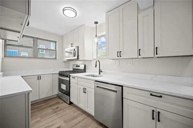 a kitchen with a sink cabinets and appliances