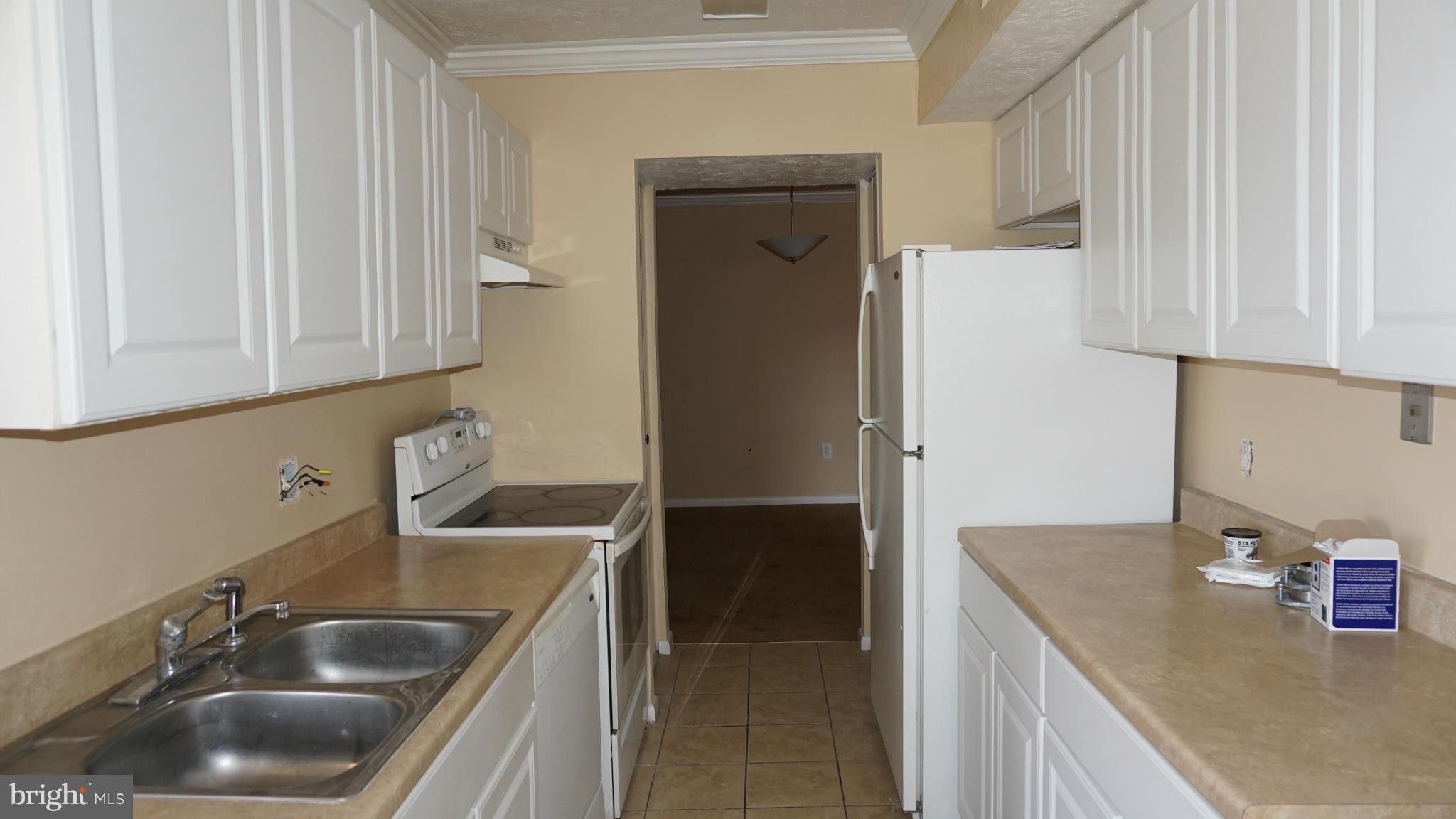 7923 Mandan Road, Unit 301 Greenbelt, MD 20770 - Photo 3 of 9 a kitchen with stainless steel appliances granite countertop a sink and a refrigerator