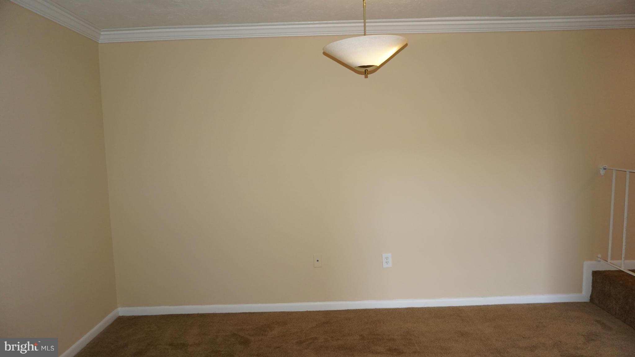 7923 Mandan Road, Unit 301 Greenbelt, MD 20770 - Photo 4 of 9 a view of a room with racks on the wall