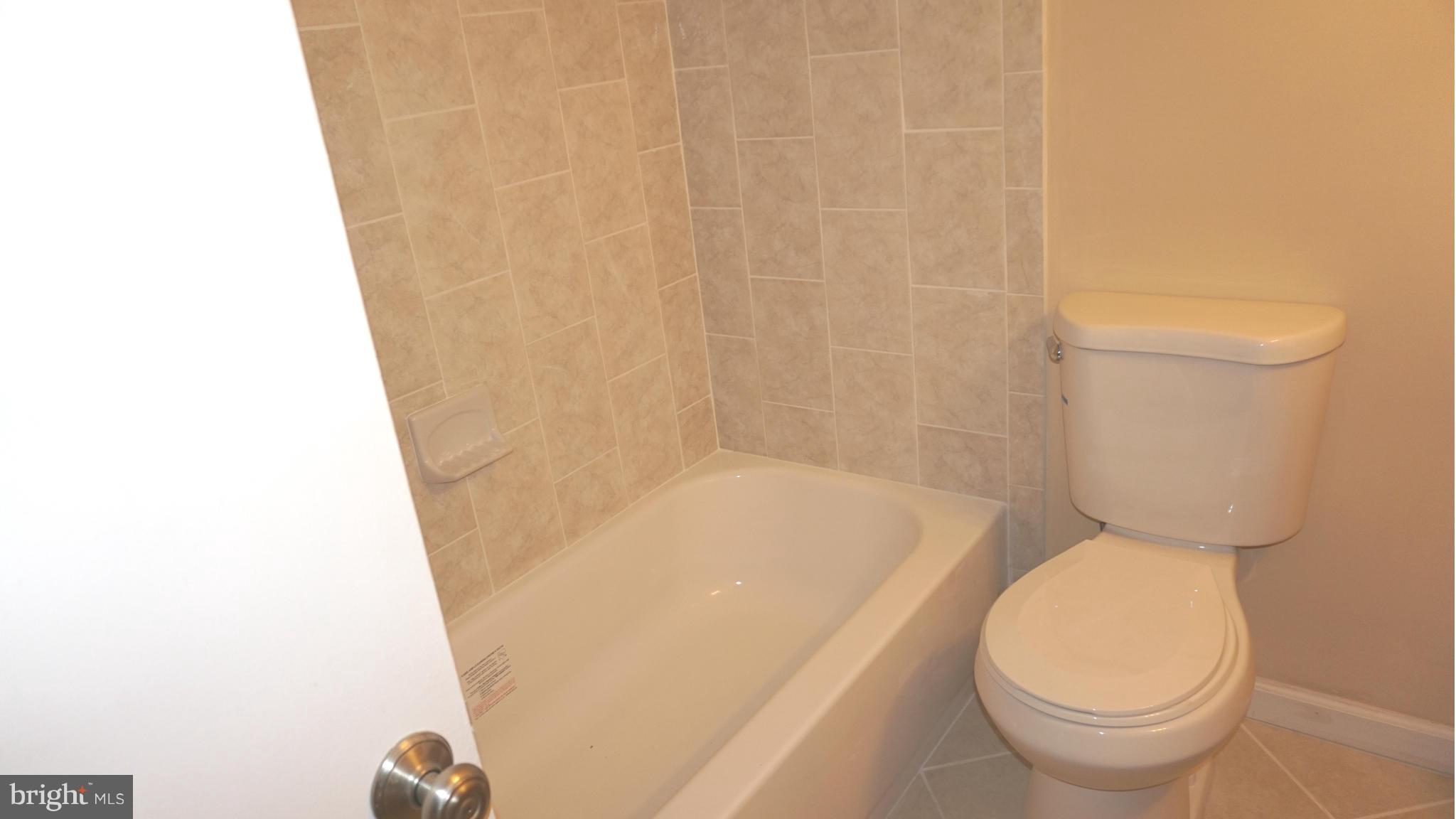 7923 Mandan Road, Unit 301 Greenbelt, MD 20770 - Photo 5 of 9 a bathroom with a toilet and a shower