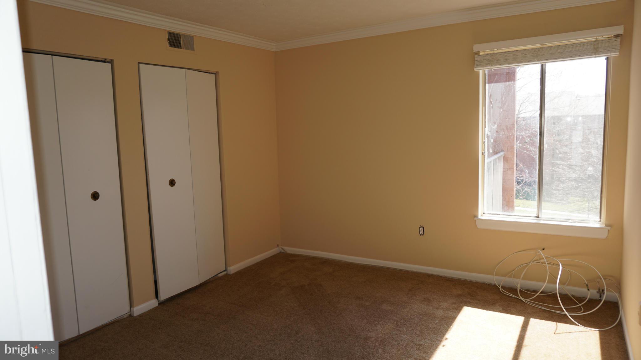 7923 Mandan Road, Unit 301 Greenbelt, MD 20770 - Photo 6 of 9 an empty room with windows