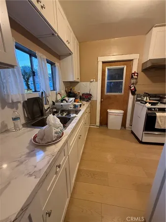 a kitchen with stainless steel appliances a stove a sink and a refrigerator