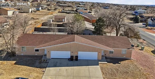 an aerial view of a house with a yard