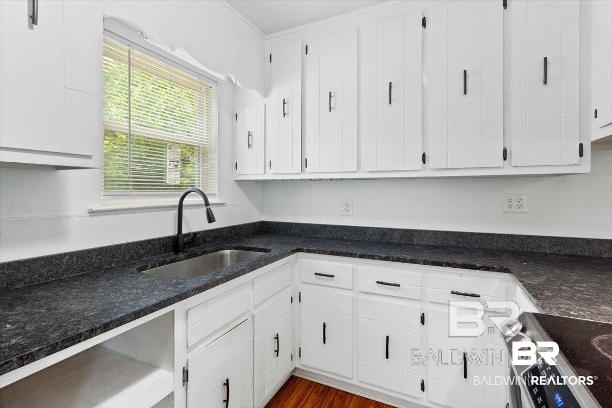 29397 Loper Road Loxley, AL 36551 - Photo 11 of 22 Kitchen featuring stainless steel electric stove, white cabinets, ornamental molding, and dark wood-style floors