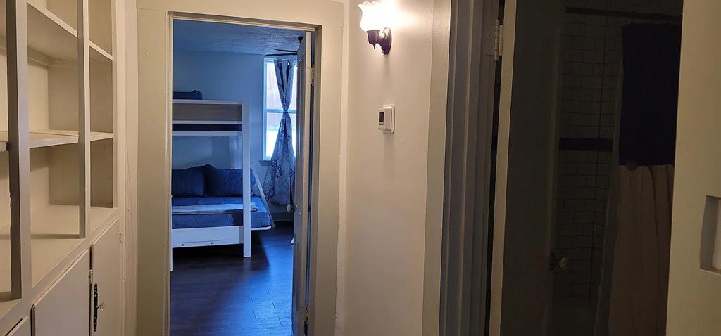 910 Baird Street Cleburne, TX 76033 - Photo 22 of 30 HALLWAY WITH BUILT-IN SHELVES