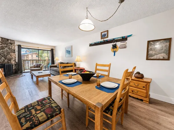 a dining room with furniture and wooden floor