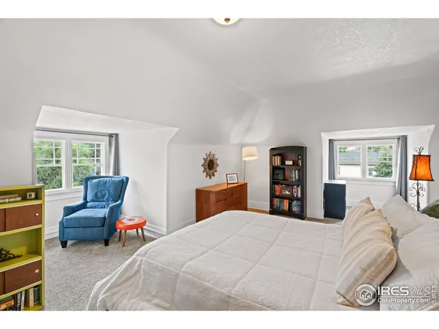 a bedroom with a bed window and a couch