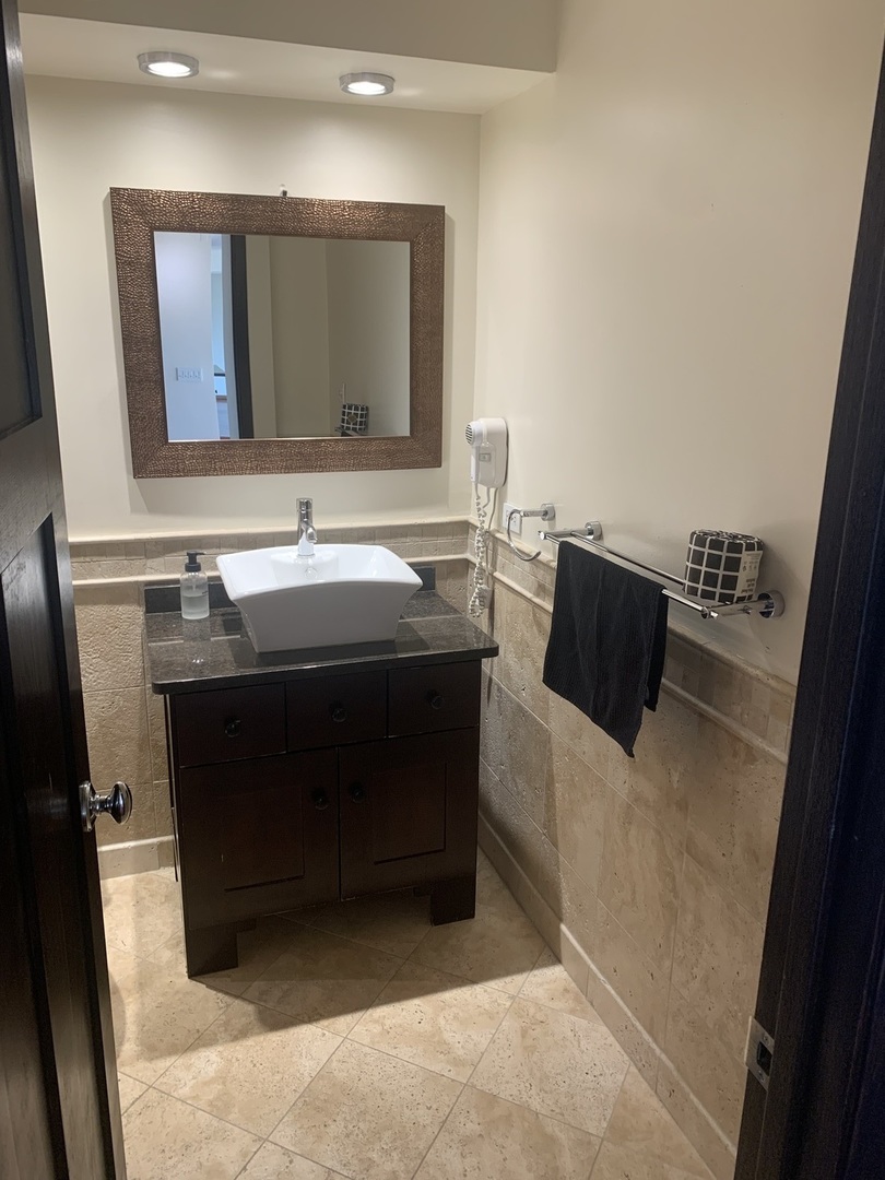 2800 North Lake Shore Drive, Unit 712 Chicago, IL 60657 - Photo 11 of 15 a bathroom with a sink and a mirror