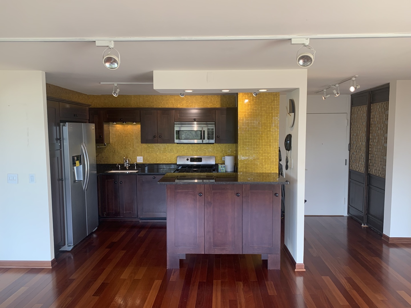 2800 North Lake Shore Drive, Unit 712 Chicago, IL 60657 - Photo 13 of 15 a kitchen with wooden floors and cabinets