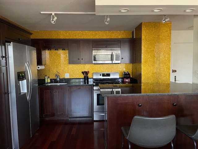 2800 North Lake Shore Drive, Unit 712 Chicago, IL 60657 - Photo 6 of 15 a kitchen with stainless steel appliances granite countertop a refrigerator a sink and a stove