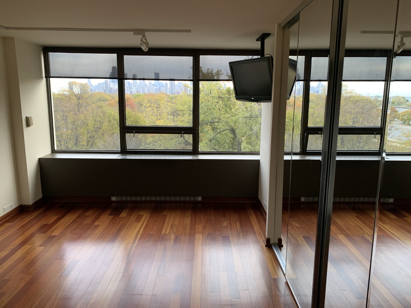 2800 North Lake Shore Drive, Unit 712 Chicago, IL 60657 - Photo 8 of 15 a view of an empty room with wooden floor and a window