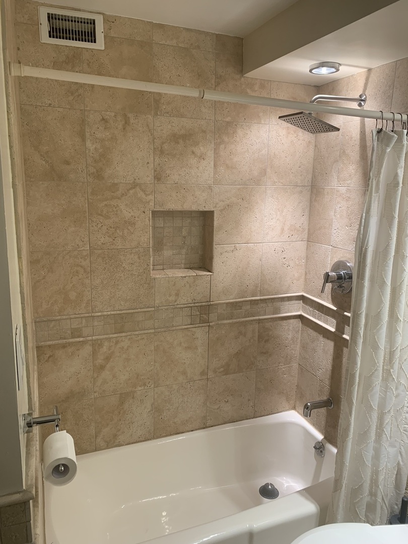 2800 North Lake Shore Drive, Unit 712 Chicago, IL 60657 - Photo 10 of 15 a bathroom with a shower and a bath tub