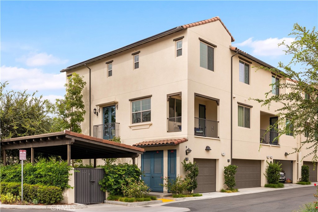 104 Coastal Garden Irvine, CA 92618 - Photo 1 of 43 a front view of a house with garage and plants