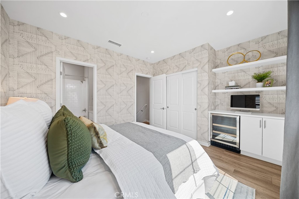 104 Coastal Garden Irvine, CA 92618 - Photo 15 of 43 a bedroom with a bed and a flat screen tv