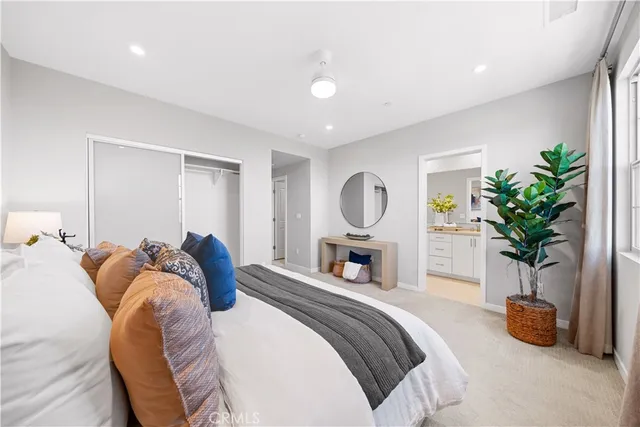 a bed room with a bed and a potted plant