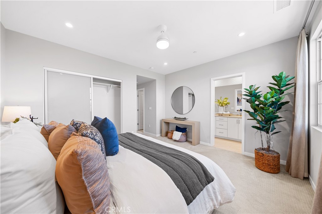 104 Coastal Garden Irvine, CA 92618 - Photo 24 of 43 a bed room with a bed and a potted plant