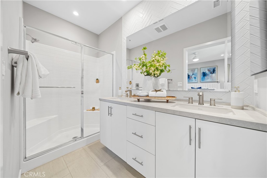 104 Coastal Garden Irvine, CA 92618 - Photo 25 of 43 a bathroom with a shower sink and mirror