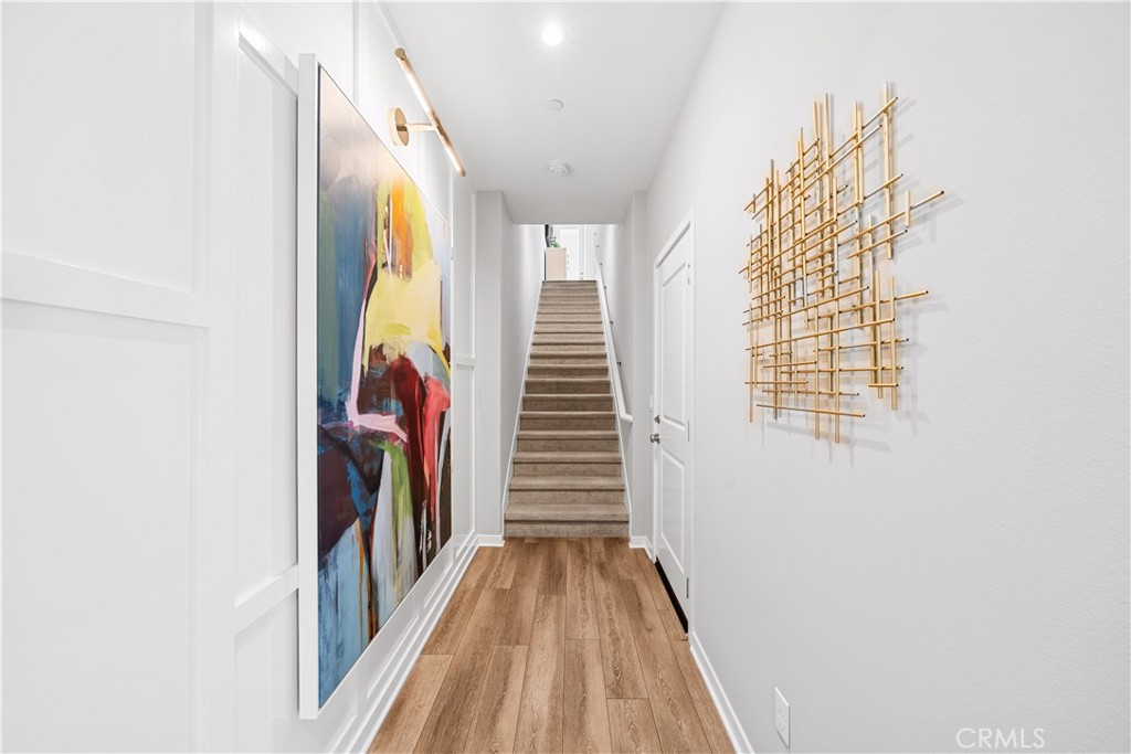 104 Coastal Garden Irvine, CA 92618 - Photo 4 of 43 a view of a hallway with wooden floor and staircase