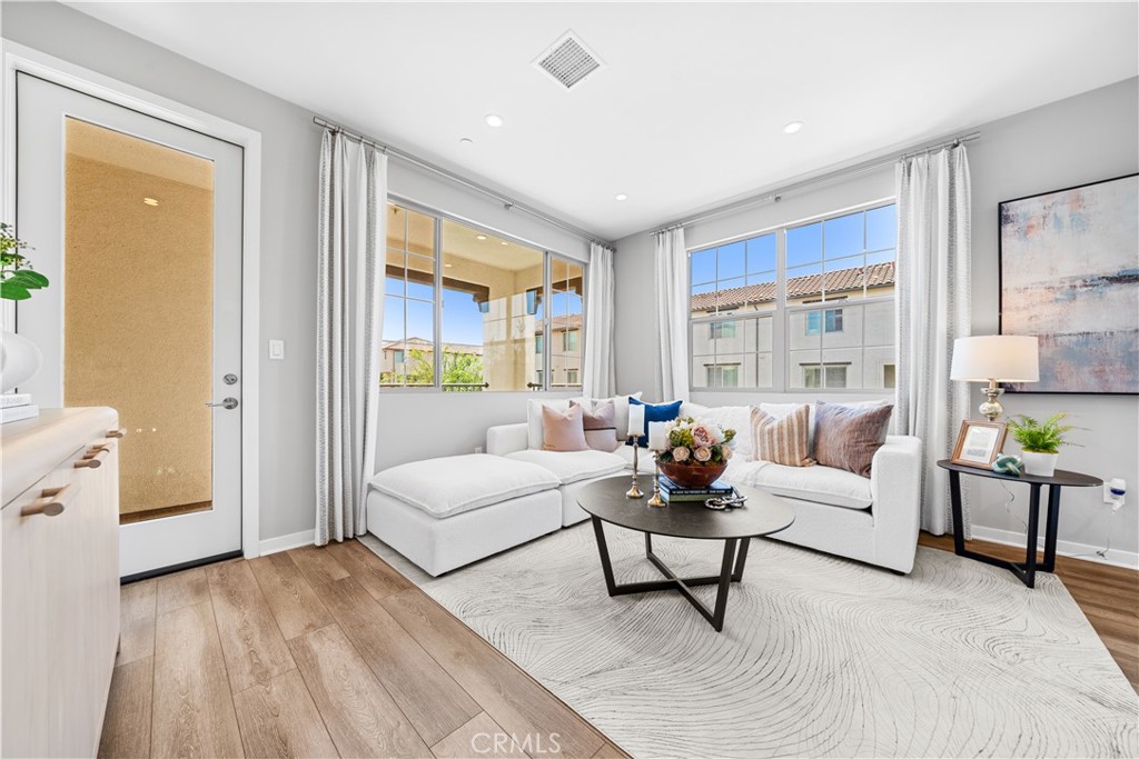 104 Coastal Garden Irvine, CA 92618 - Photo 5 of 43 a living room with furniture and a large window