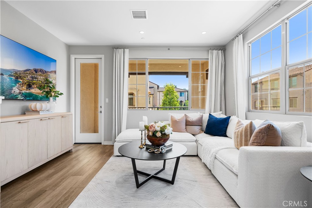 104 Coastal Garden Irvine, CA 92618 - Photo 7 of 43 a living room with furniture and a large window