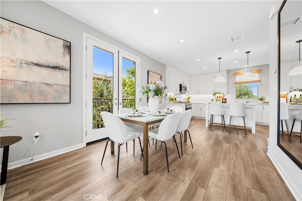 104 Coastal Garden Irvine, CA 92618 - Photo 8 of 43 a view of a dining room with furniture and wooden floor
