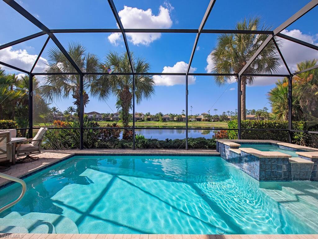 4637 Abaca Circle Naples, FL 34119 - Photo 1 of 29 a view of a swimming pool with a patio and a yard