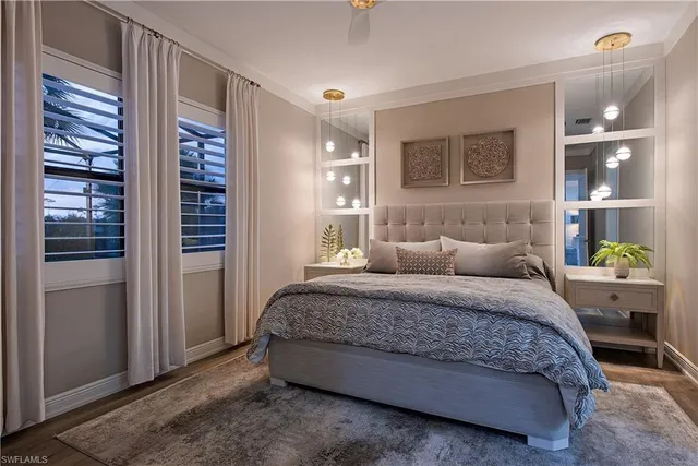a spacious bedroom with a bed and a cabinets