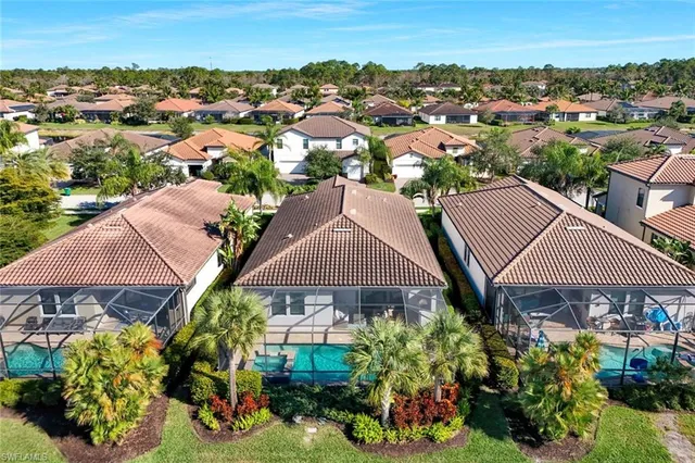 an aerial view of multiple house with a garden