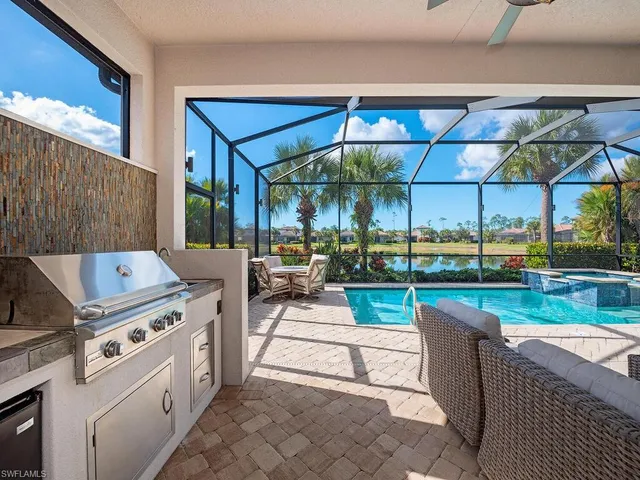 a view of a patio with a dining table and chairs under an umbrella
