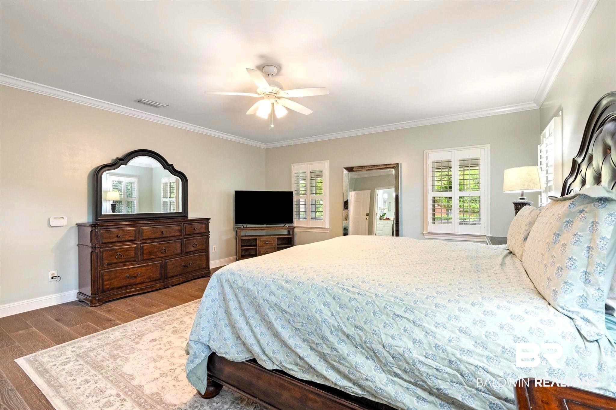 5324 Oak Bend Court Mobile, AL 36609 - Photo 22 of 49 Bedroom with crown molding, visible vents, multiple windows, and wood finished floors