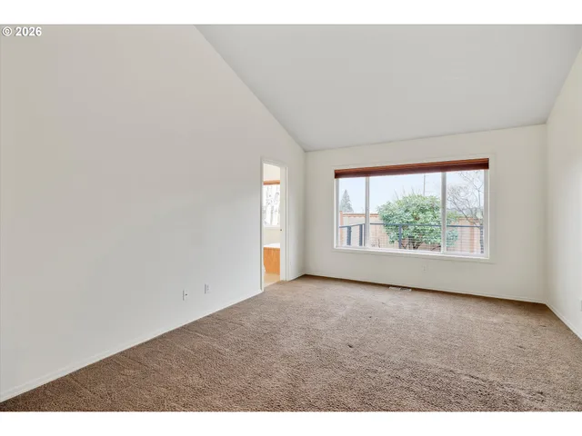 an empty room with large windows