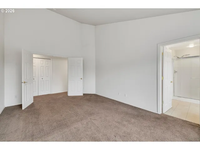 a view of an empty room and wooden floor