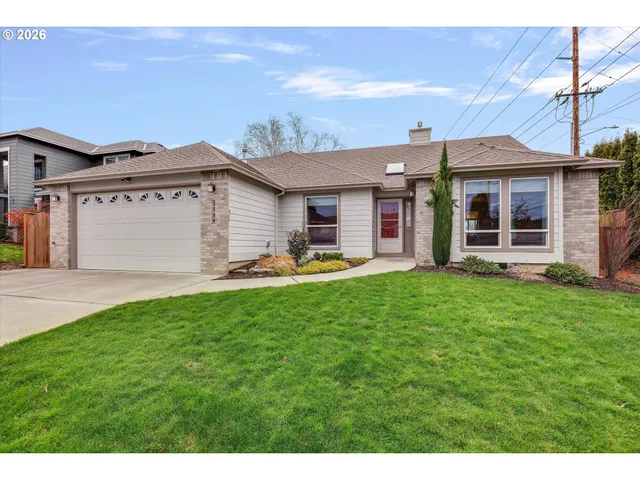 a front view of a house with a garden and yard
