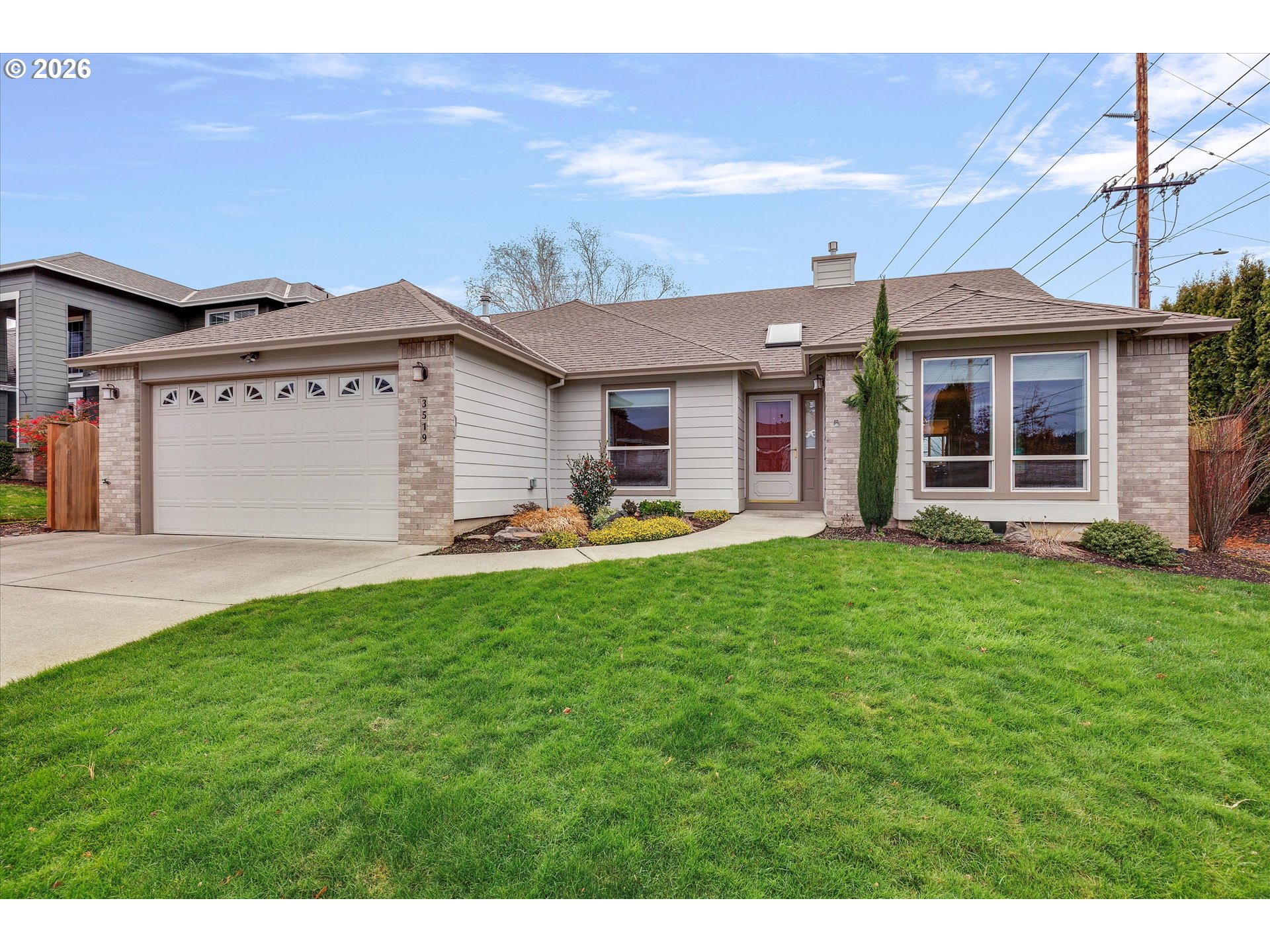 3519 Southwest 28th Terrace Gresham, OR 97080 - Photo 2 of 31 a front view of a house with a garden and yard