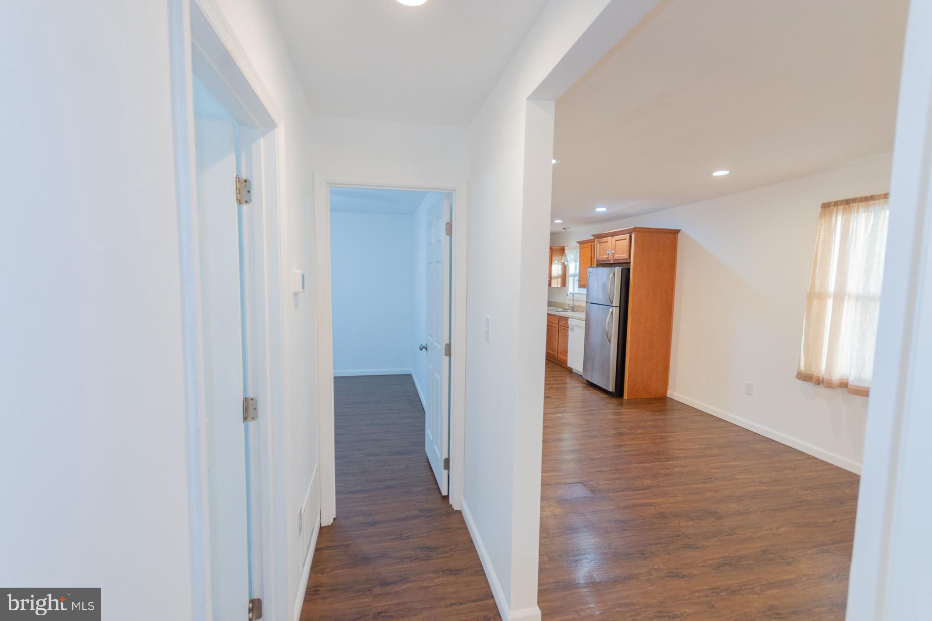 300 West 4th Avenue Ranson, WV 25438 - Photo 14 of 45 a view of a hallway with wooden floor and windows