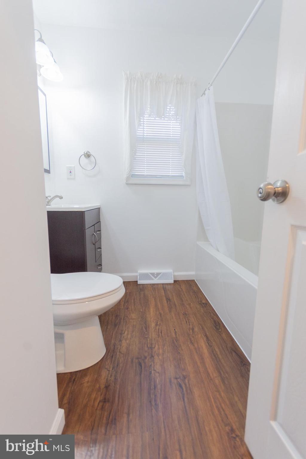 300 West 4th Avenue Ranson, WV 25438 - Photo 20 of 45 a bathroom with a toilet a sink and mirror