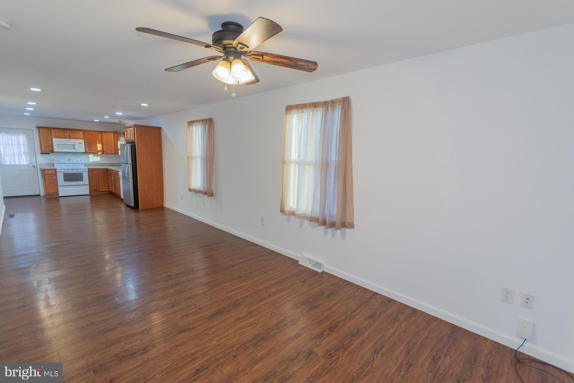 300 West 4th Avenue Ranson, WV 25438 - Photo 2 of 45 a view of an empty room with a window and wooden floor