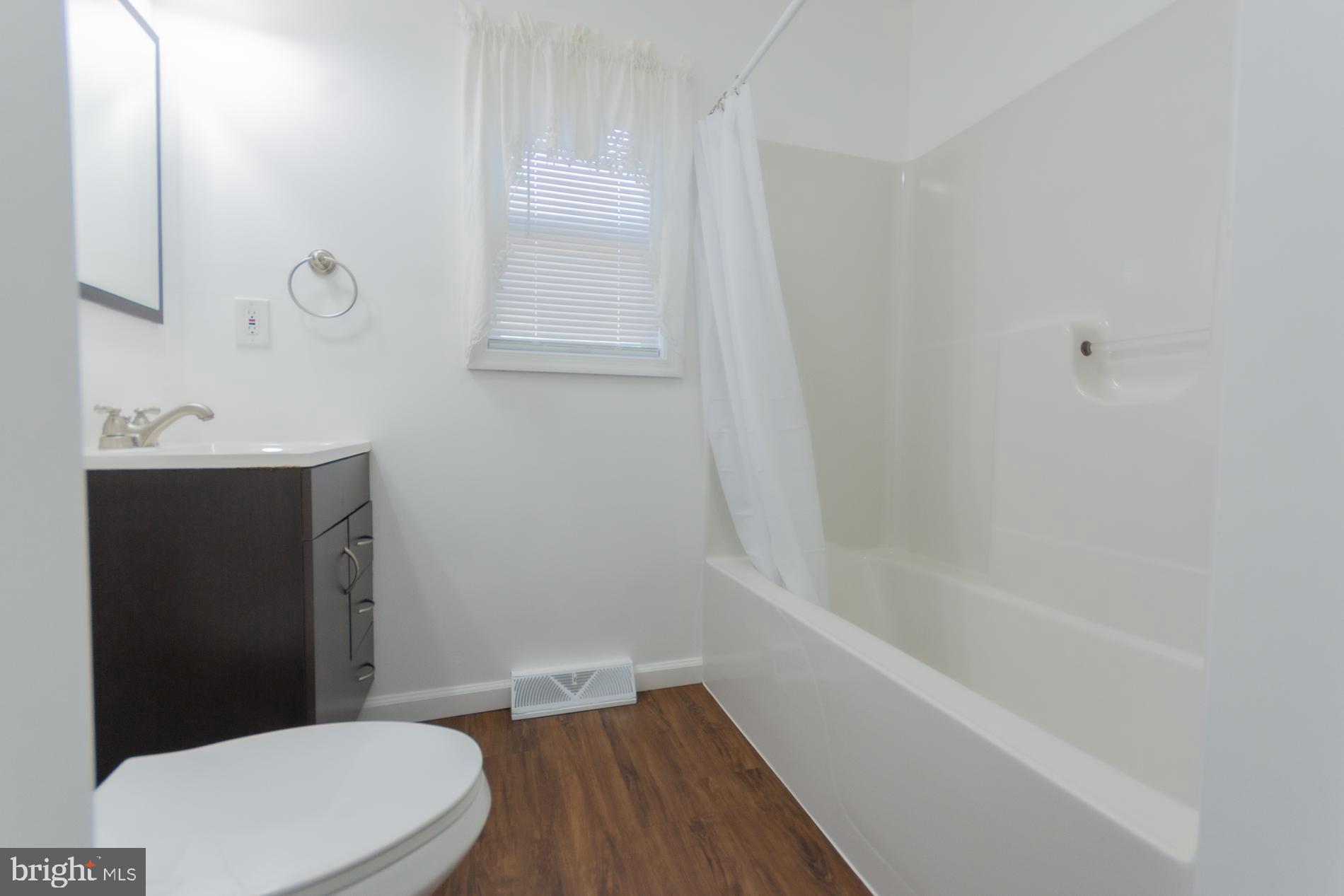 300 West 4th Avenue Ranson, WV 25438 - Photo 21 of 45 a bathroom with a sink a toilet and shower