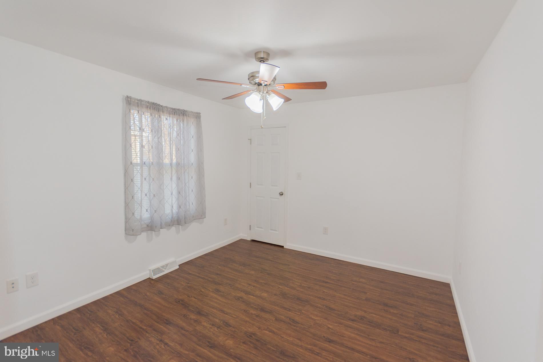 300 West 4th Avenue Ranson, WV 25438 - Photo 22 of 45 wooden floor in an empty room with a window