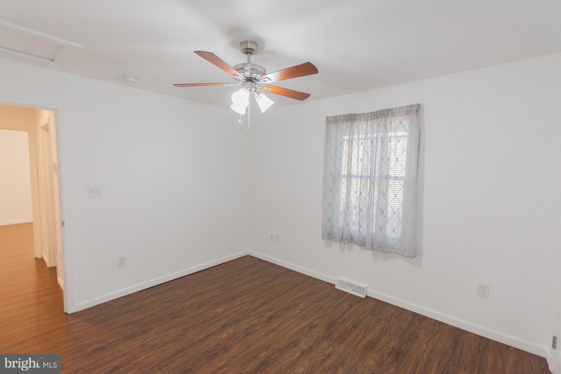 300 West 4th Avenue Ranson, WV 25438 - Photo 25 of 45 a view of empty room with wooden floor and fan