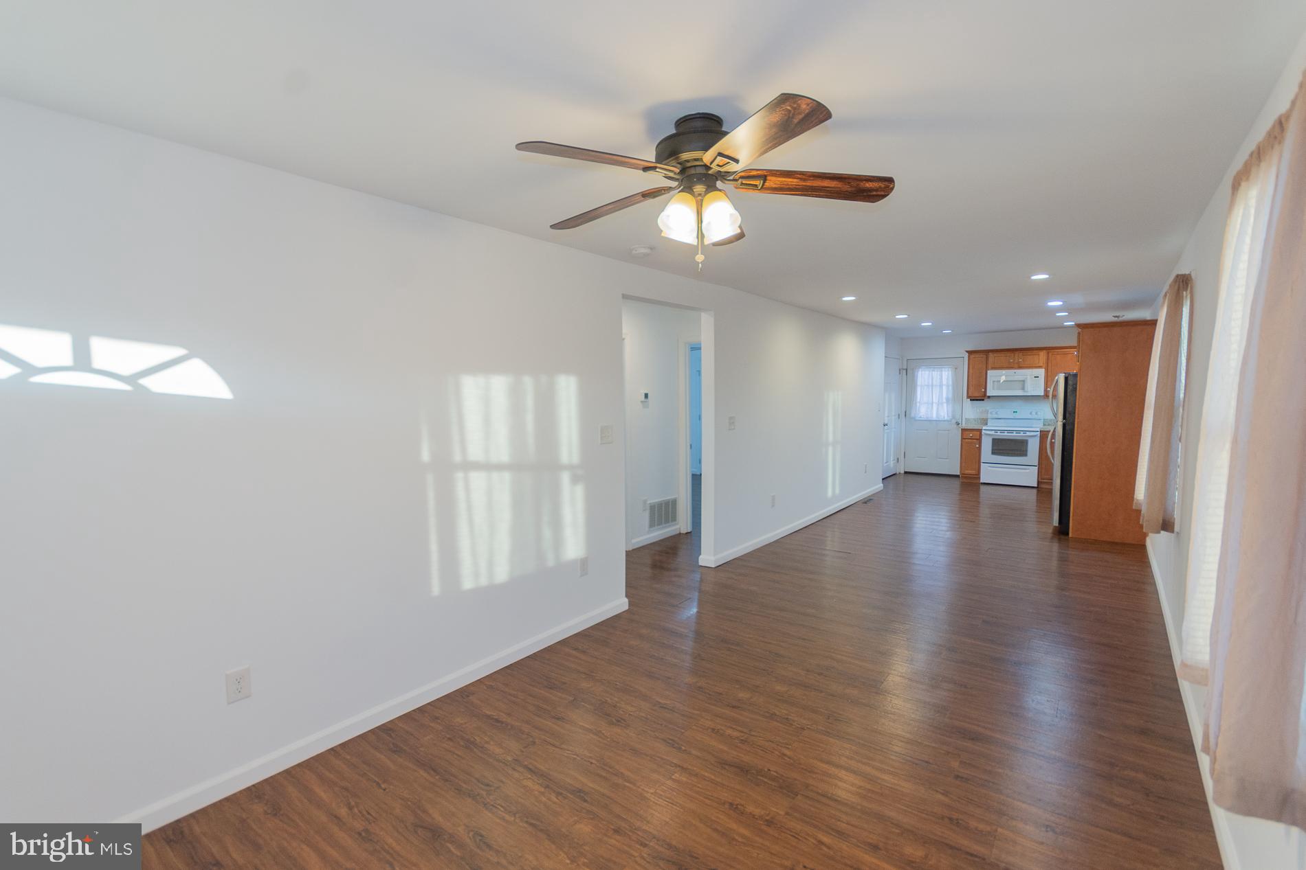 300 West 4th Avenue Ranson, WV 25438 - Photo 3 of 45 a view of empty room with wooden floor and fan