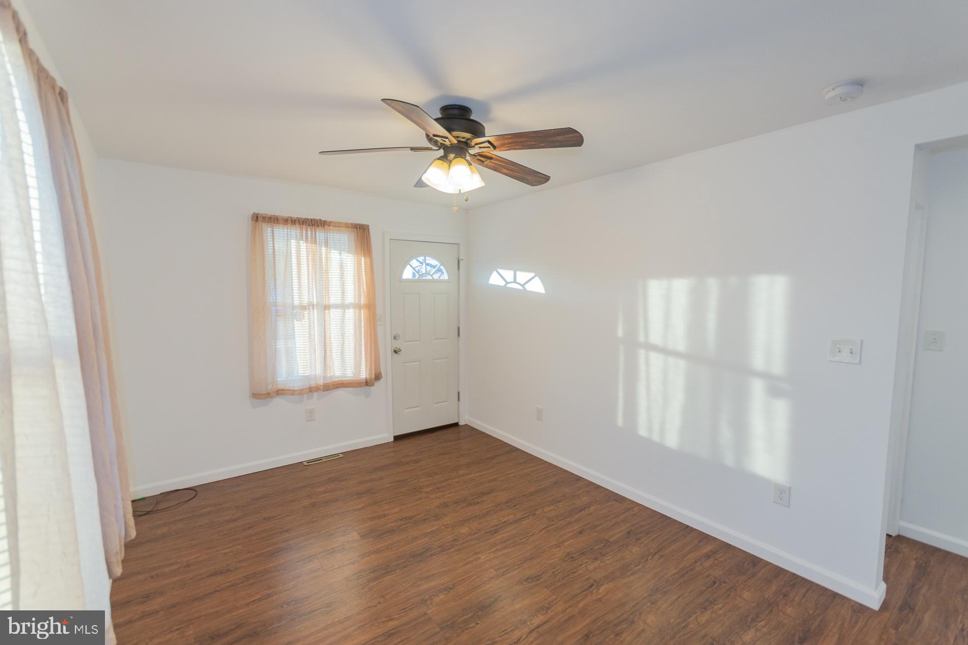 300 West 4th Avenue Ranson, WV 25438 - Photo 4 of 45 a view of empty room with wooden floor and fan