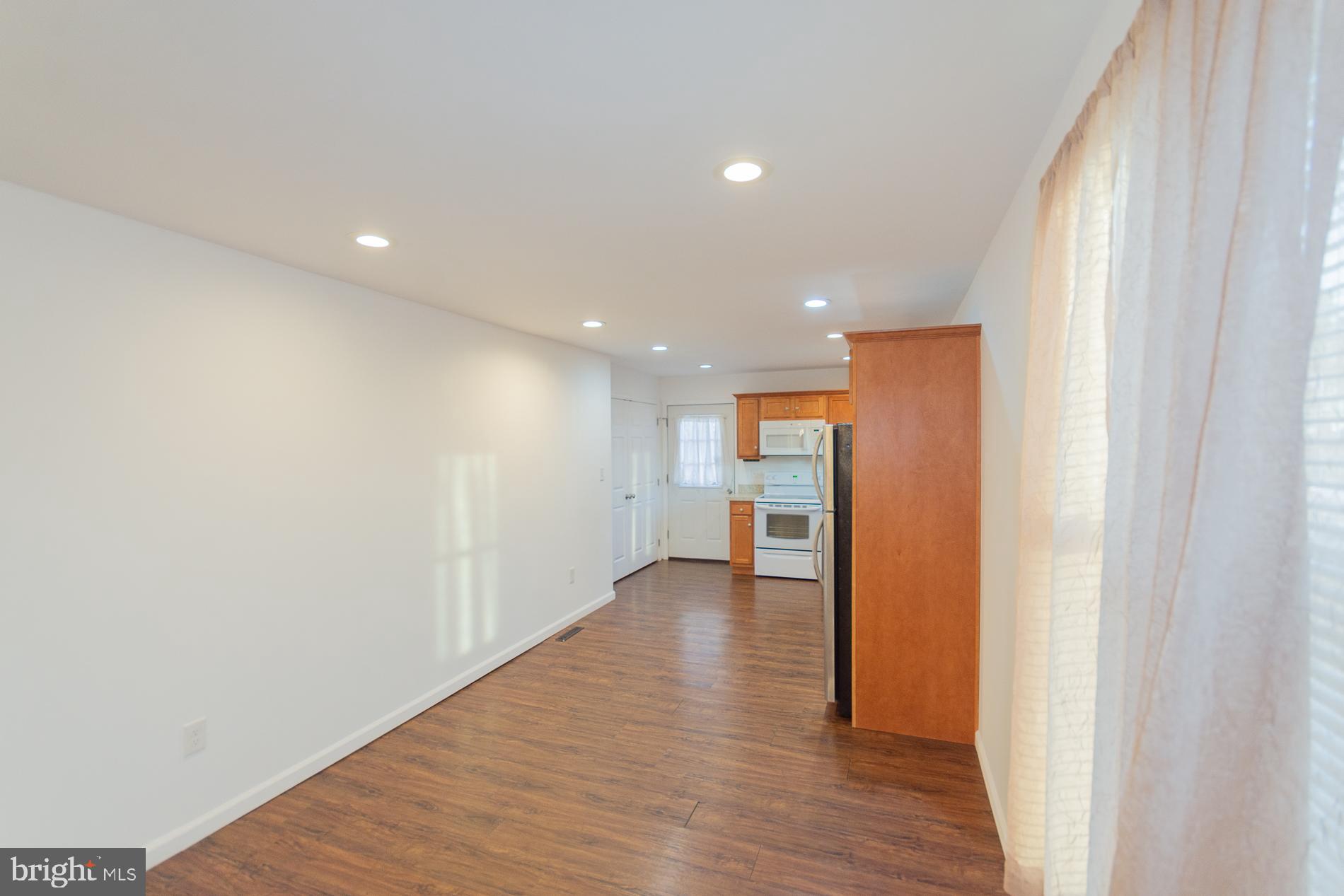 300 West 4th Avenue Ranson, WV 25438 - Photo 7 of 45 a view of a hallway with wooden floor