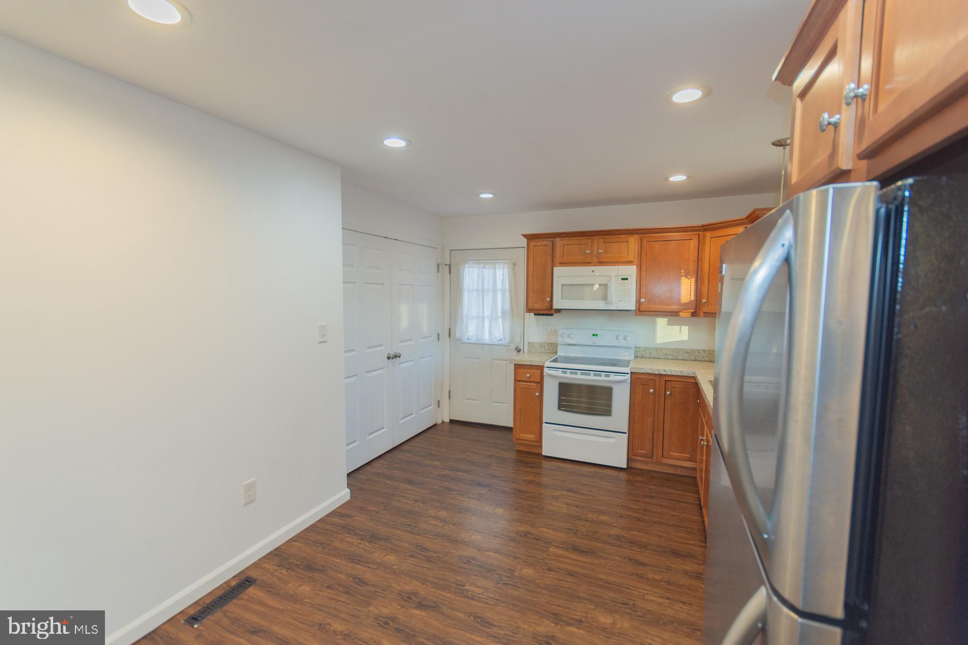 300 West 4th Avenue Ranson, WV 25438 - Photo 9 of 45 a kitchen with stainless steel appliances a refrigerator and wooden floor